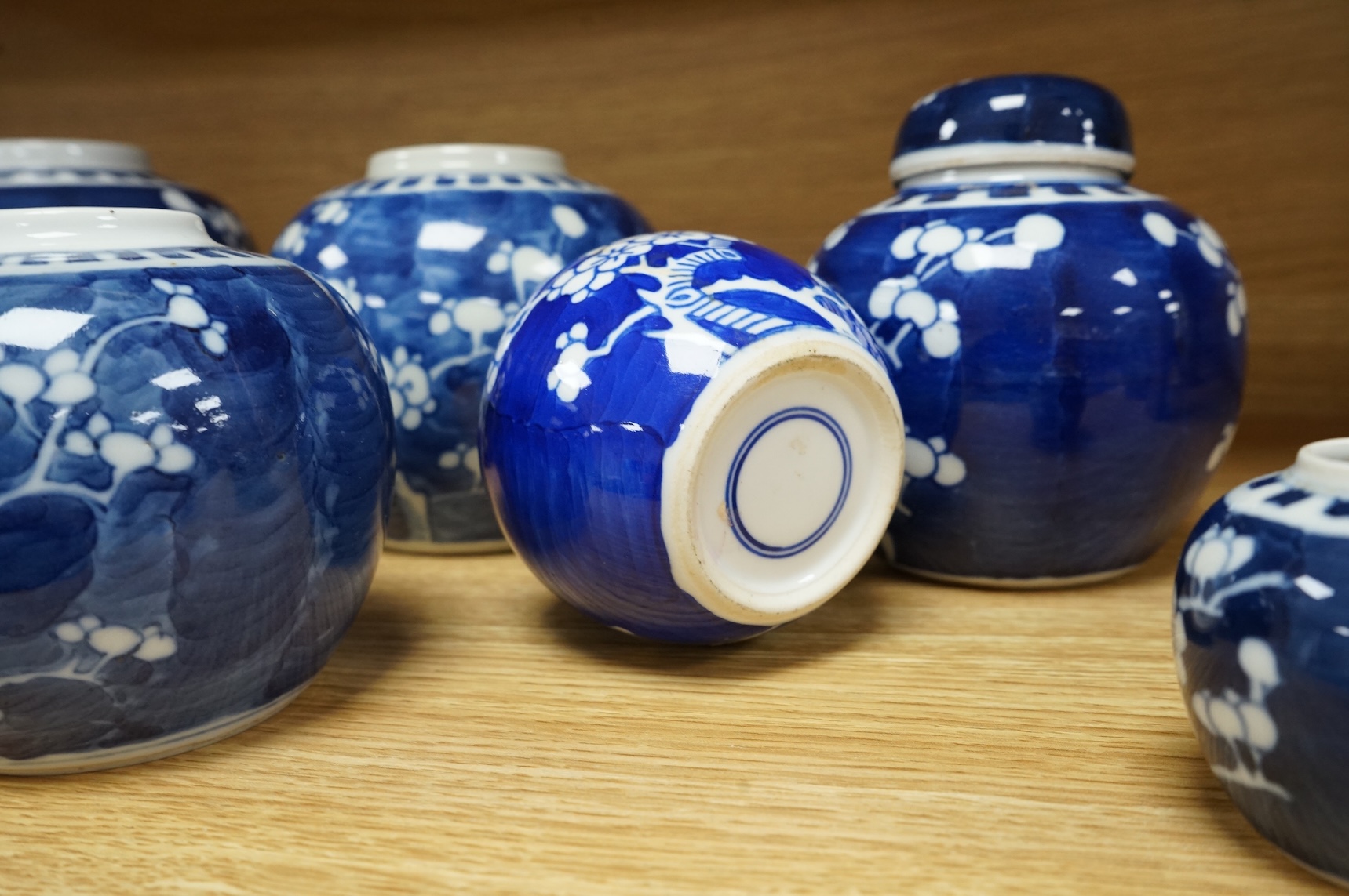 Eleven Chinese blue and white prunus jars, and two covers, late 19th/20th century, largest 16cm high